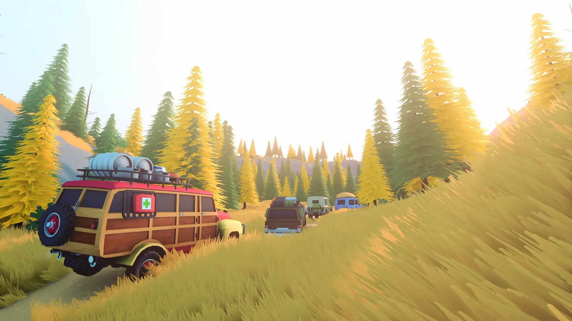 A convoy of off-road vehicles driving through a yellow larch forest in over the hill